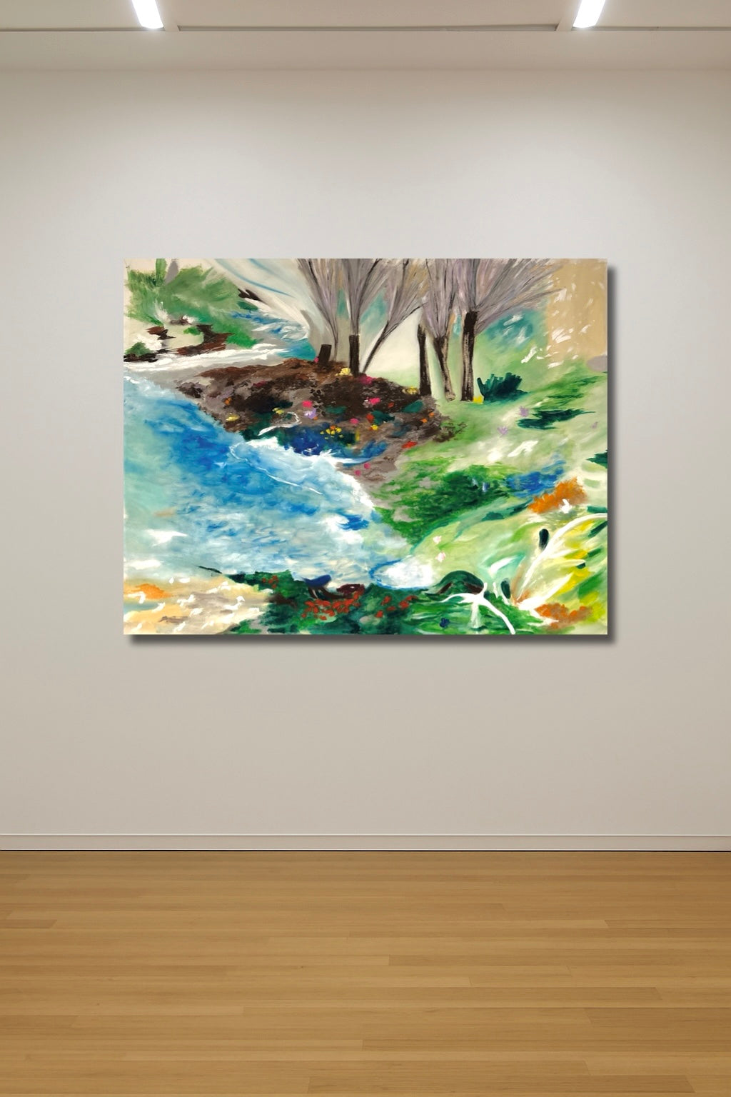 Colorful landscape painting on a white wall with wooden floor